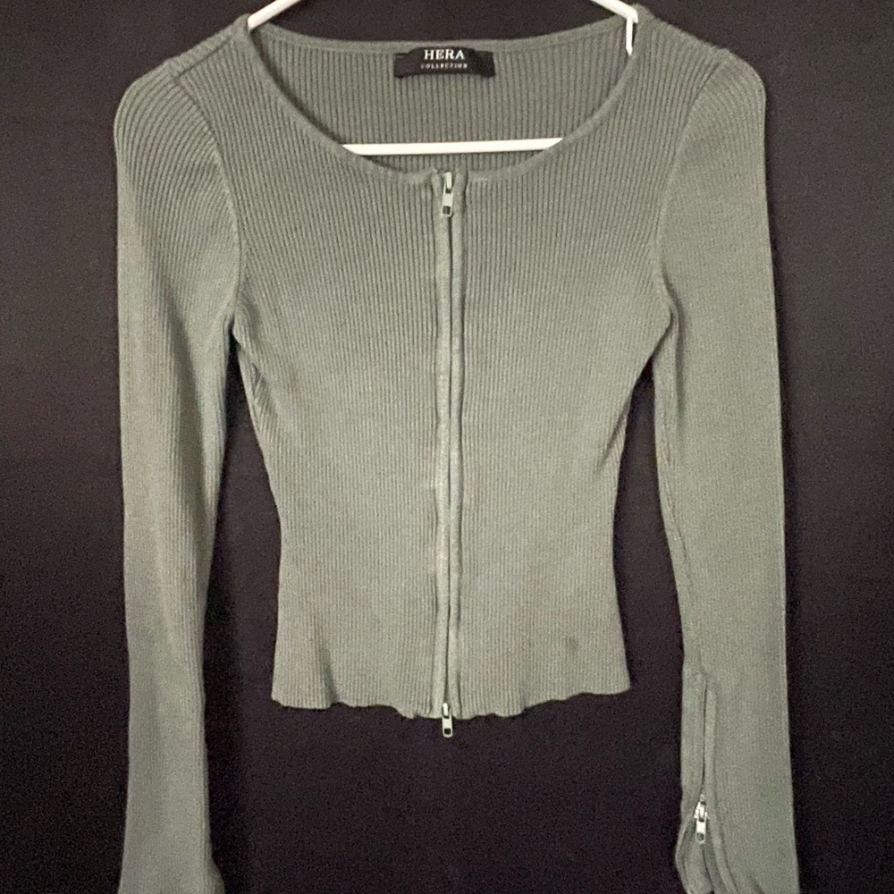 Long sleeve, zip front, cardigan, with zippers on the sleeve.